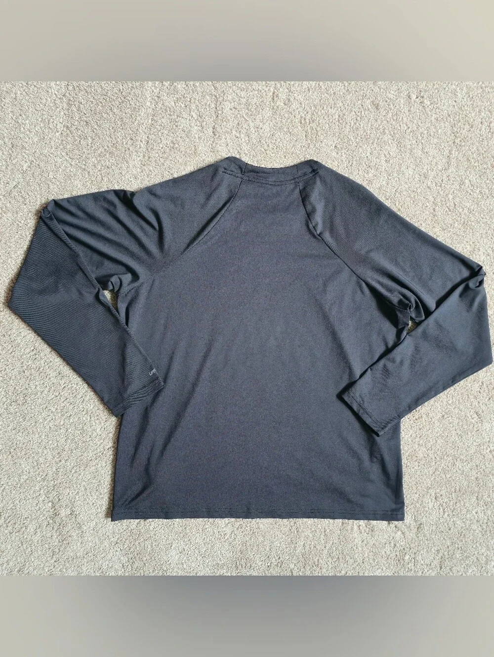 Nike Swim Dri-FIT long-sleeve Rashguard features a classic athletic crewneck